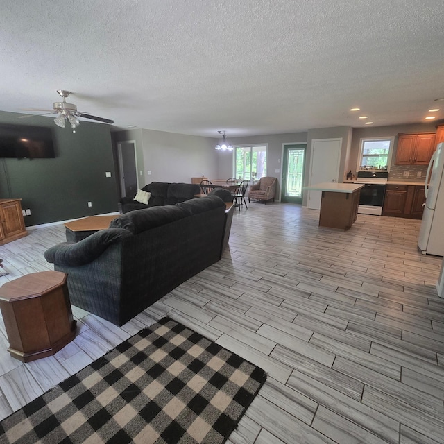 17544 366th St, Bagley, MN 56621 - living room with a textured ceiling, wood finish floors, a chandelier, and recessed lighting