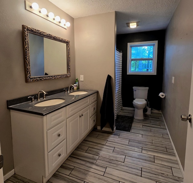 17544 366th St, Bagley, MN 56621 - full bath featuring wood tiled floors, double vanity, a textured ceiling, and curtained shower