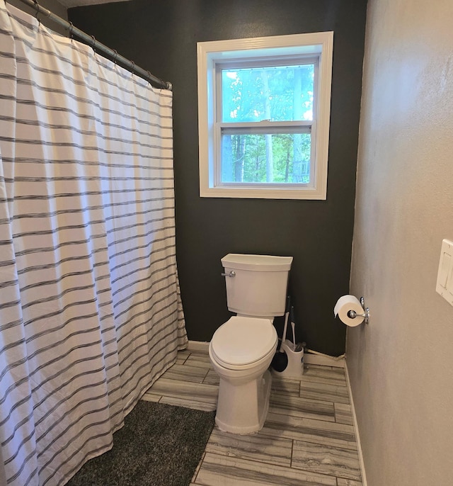 17544 366th St, Bagley, MN 56621 - full bath featuring wood finished floors and a shower with shower curtain