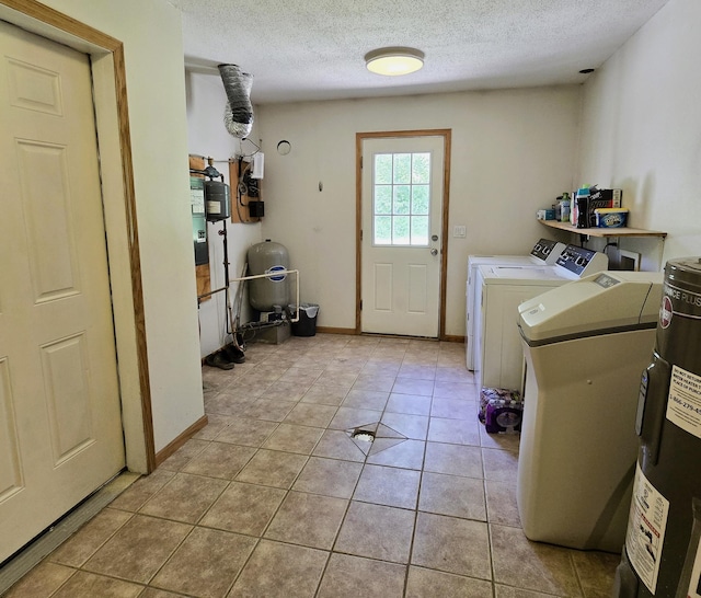 17544 366th St, Bagley, MN 56621 - washroom featuring washer and dryer, a textured ceiling, light tile patterned floors, and water heater