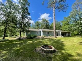 17544 366th St, Bagley, MN 56621 - back of house with a fire pit and a lawn