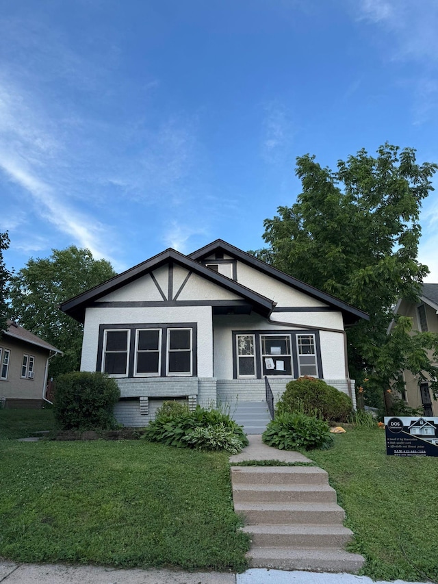 1714 Vincent Ave N, Minneapolis, MN 55411 - view of front of house featuring a front lawn, brick siding, and stucco siding