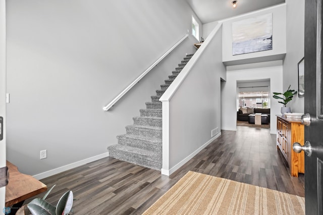 1030 Albert Dr W, West Fargo, ND 58078 - entryway featuring stairway, dark wood-style flooring, and a high ceiling