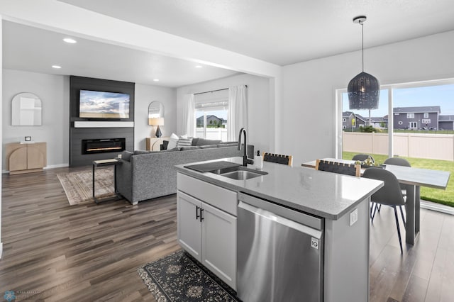1030 Albert Dr W, West Fargo, ND 58078 - kitchen with stainless steel dishwasher, dark wood-style floors, plenty of natural light, recessed lighting, and light stone countertops