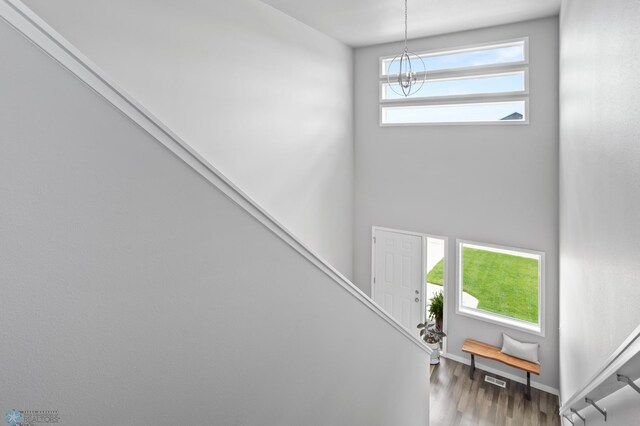 1030 Albert Dr W, West Fargo, ND 58078 - staircase featuring a chandelier and wood finished floors