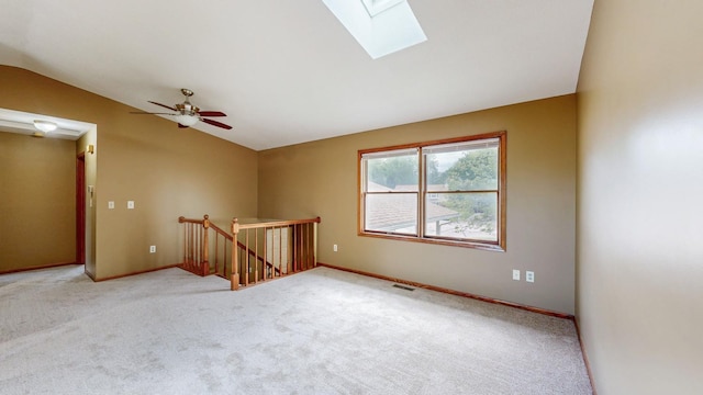 4019 Baffin Ln NE, Rochester, MN 55906 - carpeted empty room featuring vaulted ceiling, a skylight, and a ceiling fan