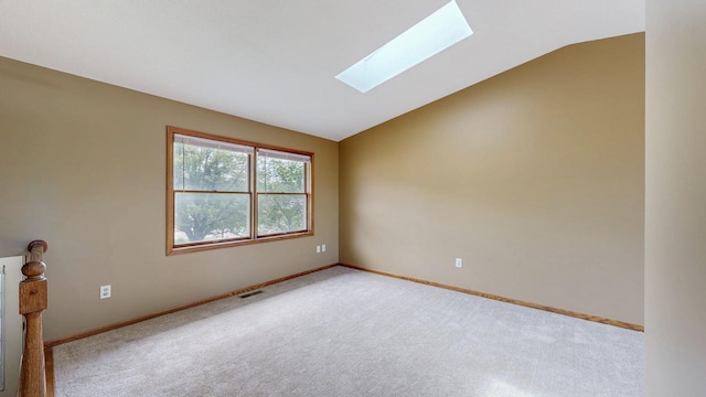 4019 Baffin Ln NE, Rochester, MN 55906 - spare room featuring a skylight, vaulted ceiling, and carpet flooring