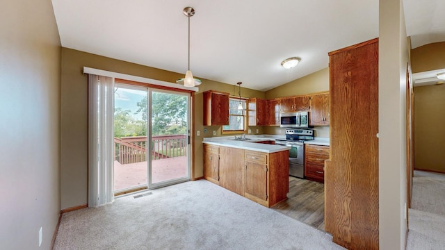 4019 Baffin Ln NE, Rochester, MN 55906 - kitchen featuring appliances with stainless steel finishes, light colored carpet, a peninsula, light countertops, and brown cabinetry