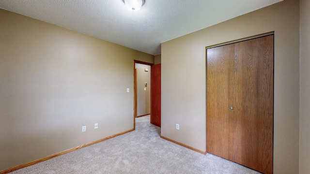 4019 Baffin Ln NE, Rochester, MN 55906 - unfurnished bedroom featuring a closet, carpet, and a textured ceiling
