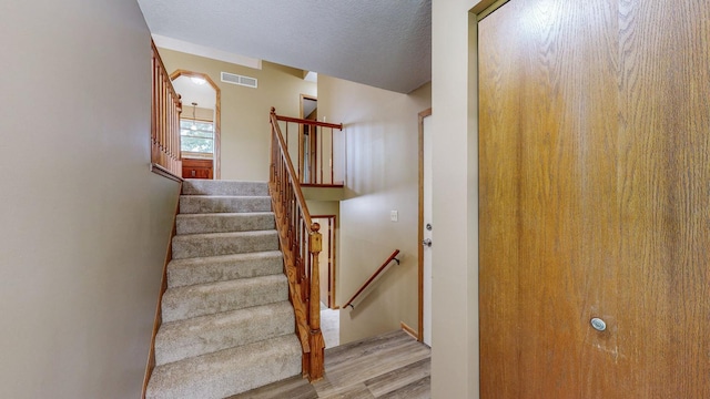 4019 Baffin Ln NE, Rochester, MN 55906 - stairs with wood finished floors and a textured ceiling