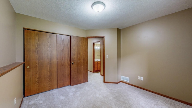 4019 Baffin Ln NE, Rochester, MN 55906 - unfurnished bedroom with light colored carpet, a closet, and a textured ceiling