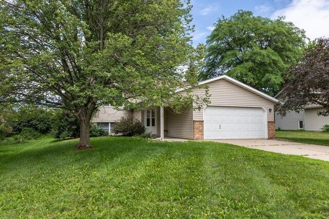 4019 Baffin Ln NE, Rochester, MN 55906 - view of front facade featuring an attached garage, driveway, a front lawn, and brick siding