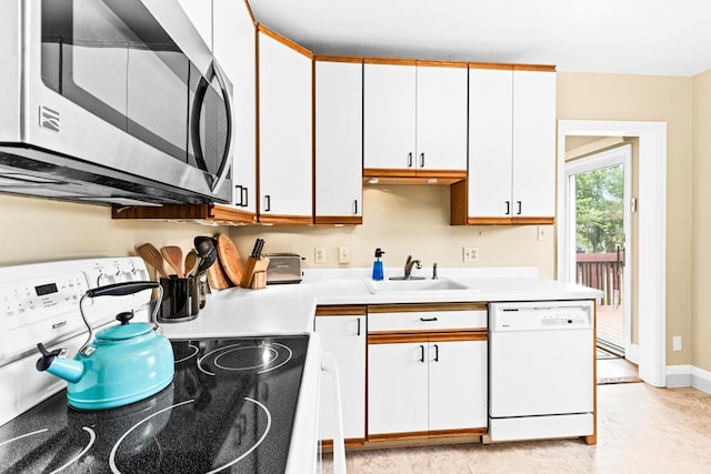 4332 Cooke St, Duluth, MN 55804 - kitchen featuring stainless steel microwave, white dishwasher, stove, light countertops, and white cabinetry