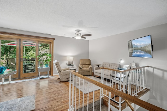 8 110th Ln NW, Coon Rapids, MN 55448 - living area featuring wood finished floors, a ceiling fan, and a textured ceiling