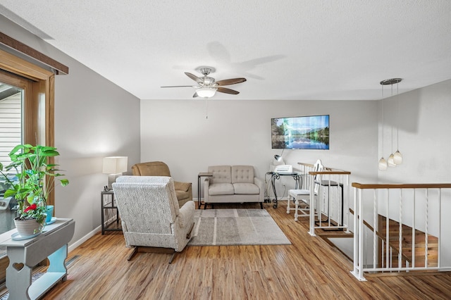 8 110th Ln NW, Coon Rapids, MN 55448 - sitting room with wood finished floors, ceiling fan, a textured ceiling, and an upstairs landing