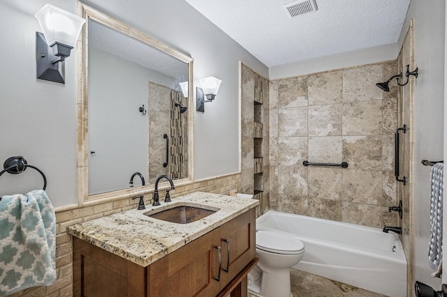 8 110th Ln NW, Coon Rapids, MN 55448 - full bath featuring vanity, tub / shower combination, a textured ceiling, wainscoting, and tile walls