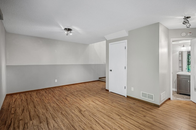 8 110th Ln NW, Coon Rapids, MN 55448 - unfurnished room with wood finished floors and a textured ceiling