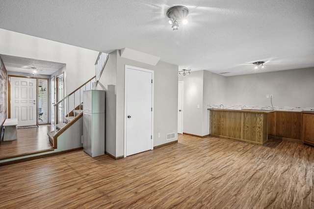 8 110th Ln NW, Coon Rapids, MN 55448 - kitchen featuring a textured ceiling and wood finished floors