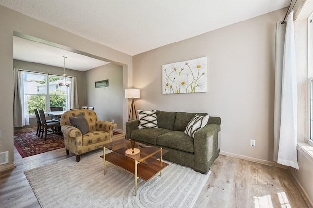 2722 Autumn Woods Dr, Chaska, MN 55318 - living room featuring wood finished floors and a chandelier