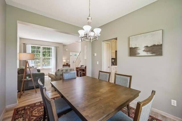 2722 Autumn Woods Dr, Chaska, MN 55318 - dining room featuring a chandelier, light wood-style floors, and stairway