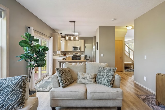 2722 Autumn Woods Dr, Chaska, MN 55318 - living room featuring light wood-type flooring and stairs