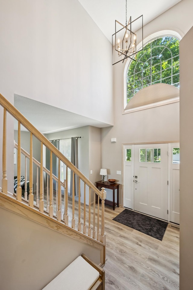 2722 Autumn Woods Dr, Chaska, MN 55318 - entrance foyer featuring a towering ceiling, plenty of natural light, light wood-type flooring, and stairway