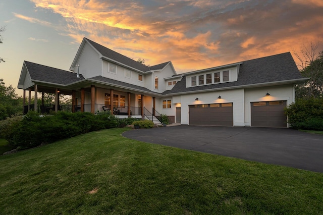 13430 Vickers St NE, Andover, MN 55304 - view of front of house featuring covered porch, asphalt driveway, a front lawn, and an attached garage