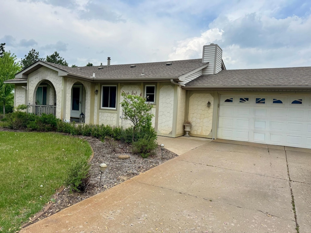 665 148th Ln NW, Andover, MN 55304 - ranch-style home featuring concrete driveway, a garage, a chimney, roof with shingles, and a front lawn