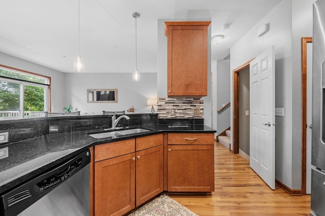 1964 Lincoln Ln, Chanhassen, MN 55317 - kitchen featuring stainless steel dishwasher, light wood finished floors, decorative light fixtures, dark stone countertops, and brown cabinetry
