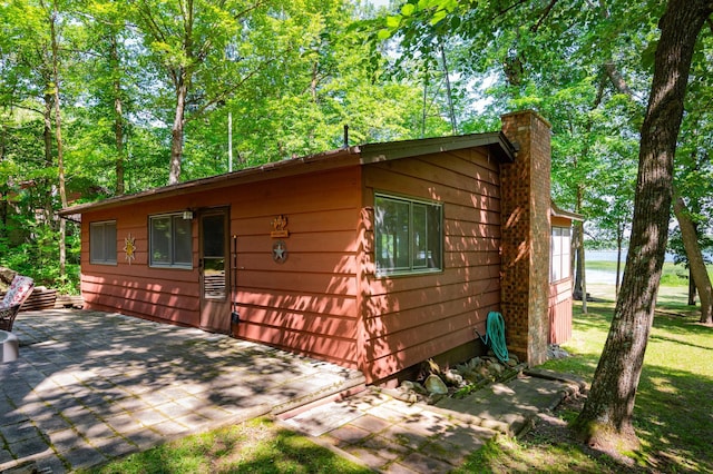 90162 Shady Oak Ln, Kerrick Twp, MN 55756 - view of property exterior with a chimney and a patio