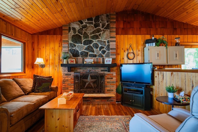 90162 Shady Oak Ln, Kerrick Twp, MN 55756 - living room featuring vaulted ceiling, wooden walls, wood finished floors, a large fireplace, and wood ceiling