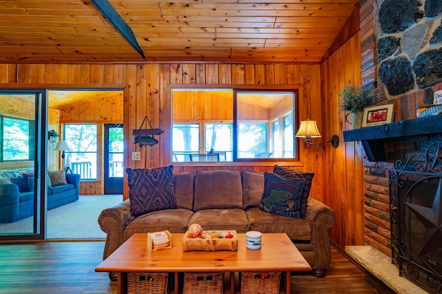 90162 Shady Oak Ln, Kerrick Twp, MN 55756 - living area featuring plenty of natural light, wood ceiling, a large fireplace, wooden walls, and hardwood / wood-style flooring