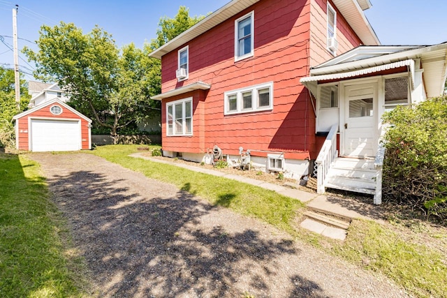 41 9th St, Cloquet, MN 55720 - view of property exterior with an outbuilding, driveway, entry steps, a garage, and cooling unit