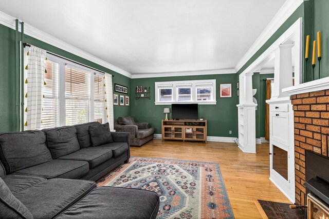 41 9th St, Cloquet, MN 55720 - living room with light wood-style floors, crown molding, and a fireplace