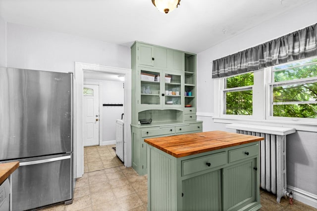 41 9th St, Cloquet, MN 55720 - kitchen featuring green cabinets, freestanding refrigerator, wood counters, and radiator heating unit