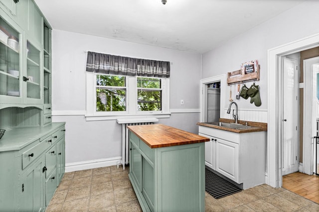 41 9th St, Cloquet, MN 55720 - kitchen featuring green cabinets, wood counters, and glass insert cabinets