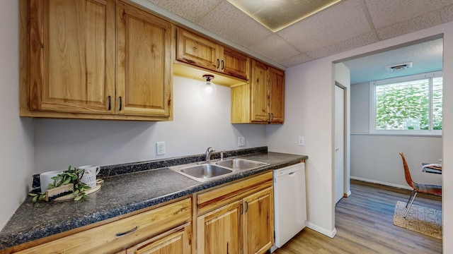 929 40th St NW, Rochester, MN 55901 - kitchen featuring white dishwasher, light wood-type flooring, dark countertops, a paneled ceiling, and brown cabinets