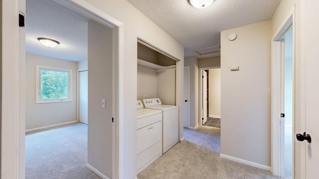 929 40th St NW, Rochester, MN 55901 - laundry area with washer and dryer, a textured ceiling, and light colored carpet