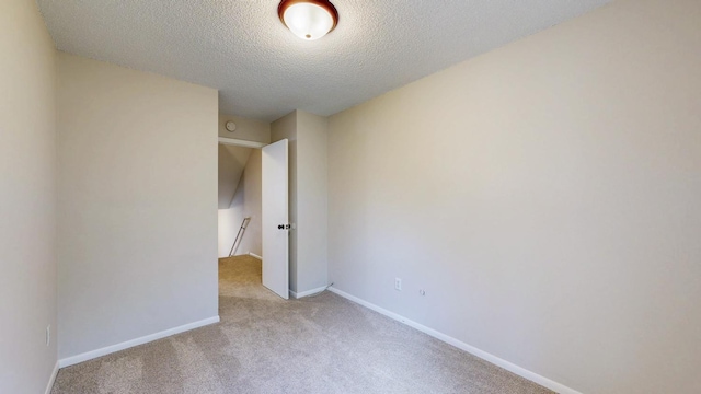 929 40th St NW, Rochester, MN 55901 - carpeted empty room featuring a textured ceiling and baseboards