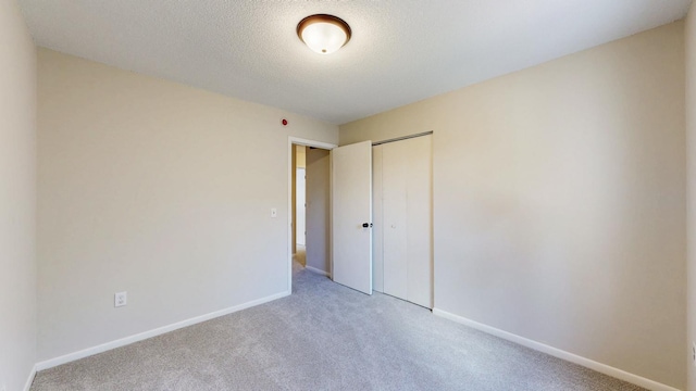 929 40th St NW, Rochester, MN 55901 - unfurnished bedroom with light carpet and a closet