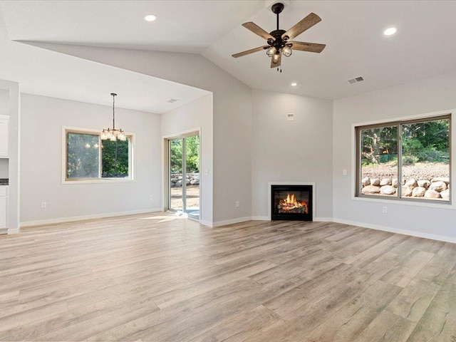 31418 Isabelle Dr, Pequot Lakes, MN 56472 - unfurnished living room featuring light wood-style flooring, ceiling fan, lofted ceiling, a glass covered fireplace, and a chandelier