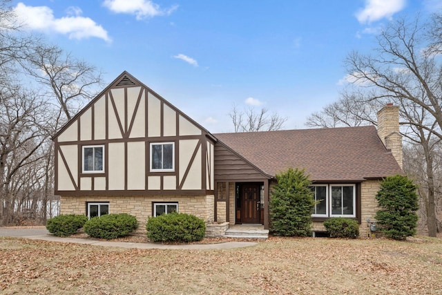 6485 46th Ave SE, Haven Twp, MN 56304 - tudor house with a chimney, roof with shingles, stucco siding, and stone siding