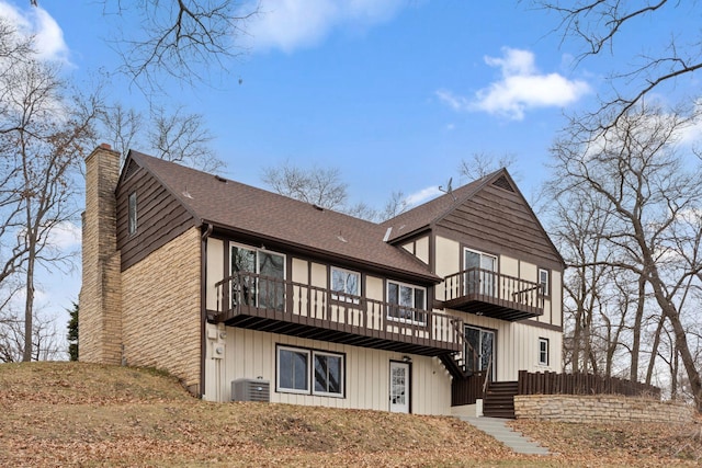 6485 46th Ave SE, Haven Twp, MN 56304 - back of house with stairway, a chimney, a balcony, roof with shingles, and a deck