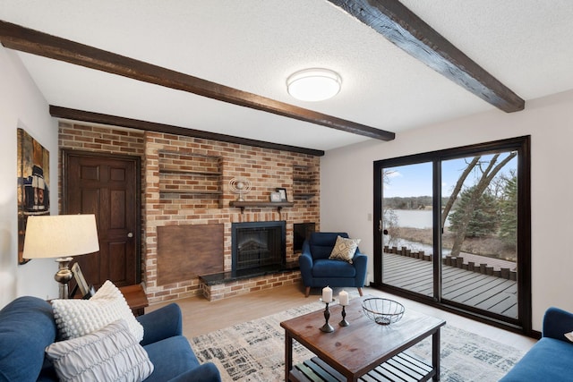 6485 46th Ave SE, Haven Twp, MN 56304 - living room featuring beam ceiling, a brick fireplace, wood finished floors, a textured ceiling, and a water view