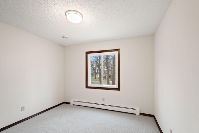 6485 46th Ave SE, Haven Twp, MN 56304 - spare room featuring baseboard heating, carpet floors, a smoke detector, and a textured ceiling