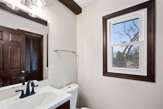 6485 46th Ave SE, Haven Twp, MN 56304 - bathroom featuring beamed ceiling and vanity