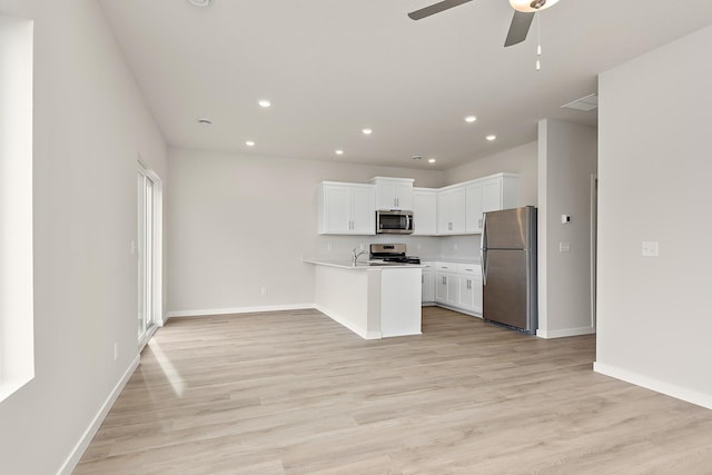 39746 Fallbrook Ave, North Branch, MN 55056 - kitchen with stainless steel appliances, ceiling fan, open floor plan, a peninsula, and light wood-type flooring