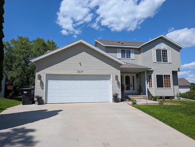 3417 42nd St NW, Rochester, MN 55901 - traditional home with concrete driveway, a garage, and a front yard