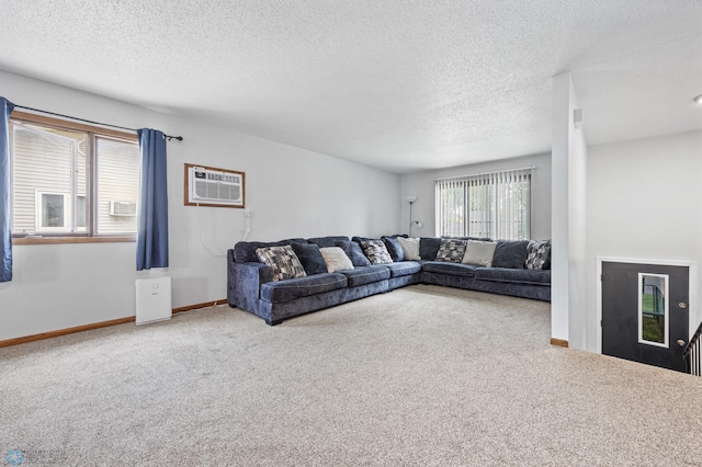 2350 20th Ave S, Fargo, ND 58103 - carpeted living room featuring a textured ceiling and a wall unit AC