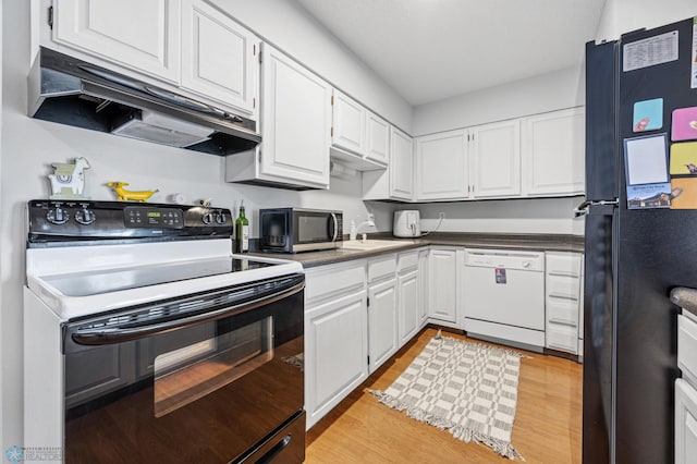 2350 20th Ave S, Fargo, ND 58103 - kitchen with black appliances, under cabinet range hood, white cabinetry, light wood finished floors, and dark countertops